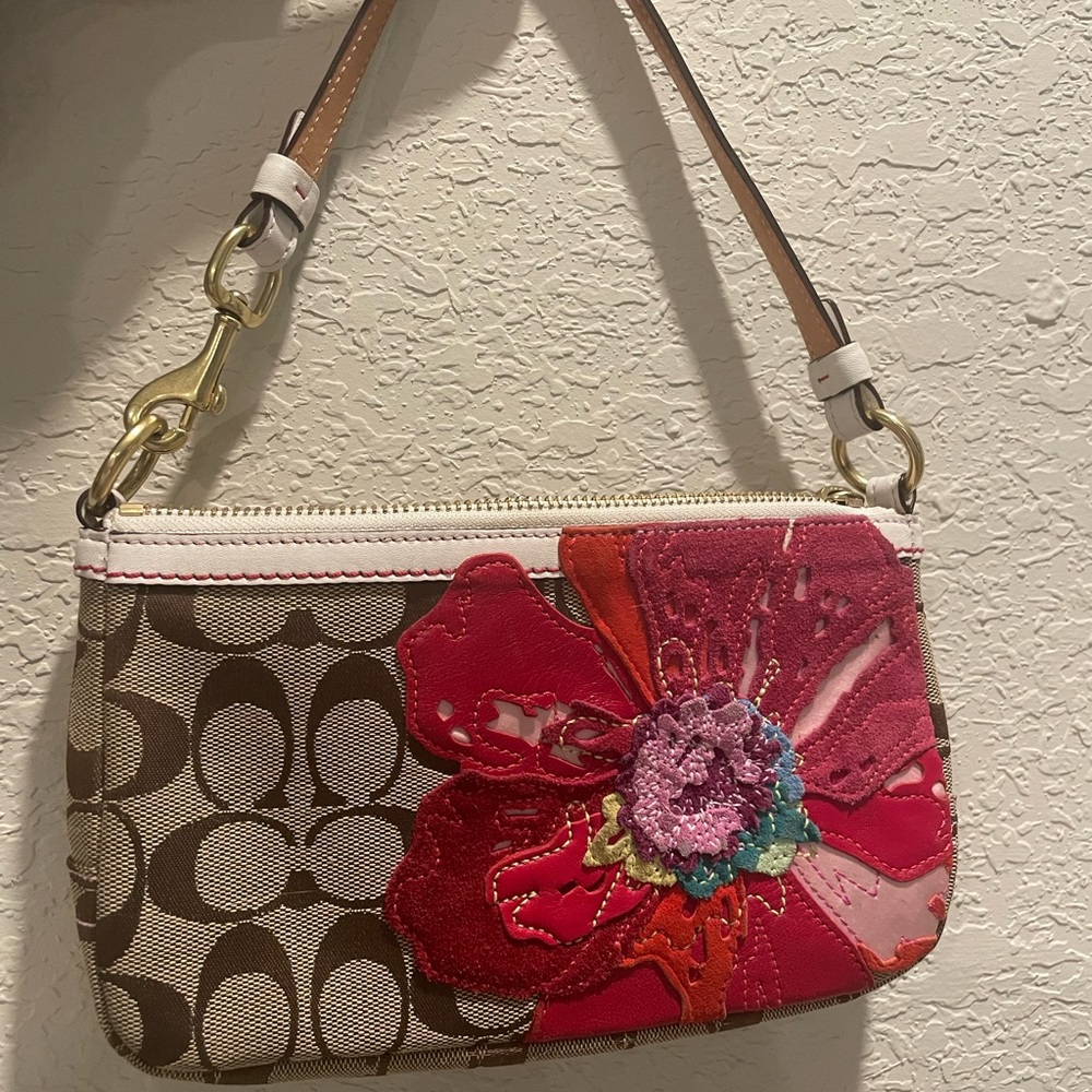 Small Coach purse with flower detail.
